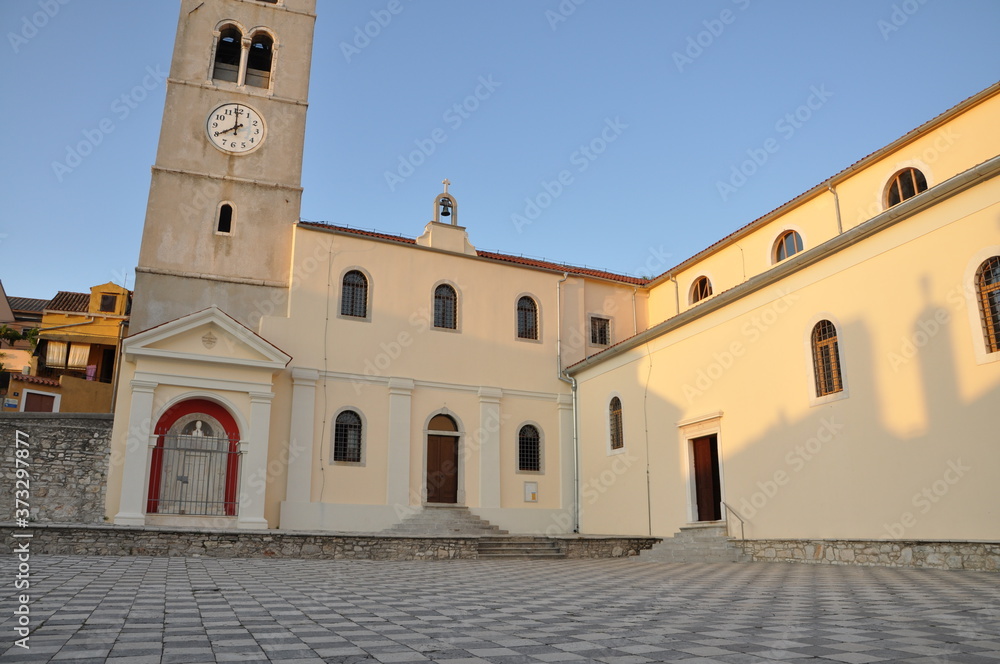 Fototapeta premium Church of the Assumption of the Blessed Virgin Mary is one of the few preserved buildings of the former Old Town of Mali Losinj.Parrish church of the nativity of the virgin at Mali Losinj.