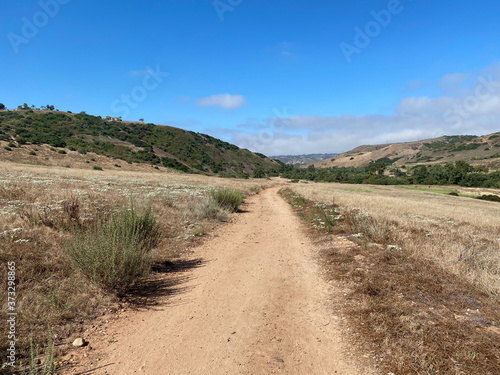 Dry dusty trails in the valley with blue sky, San Diego, California, USA