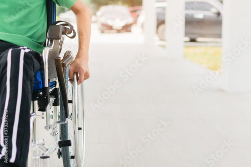 Asian special child on wheelchair wear green shirt learn how to use wheelchair on ramp for disabled people by trainer, Lifestyle in the education age of disability children, Physical Therapy concept. © GAYSORN