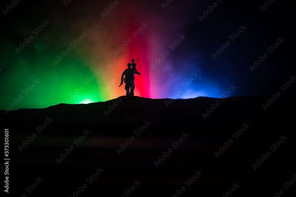 Azeri army concept. Silhouette of armed soldiers against Azerbaijani flag. Creative artwork decoration. Military silhouettes fighting scene dark toned foggy background.