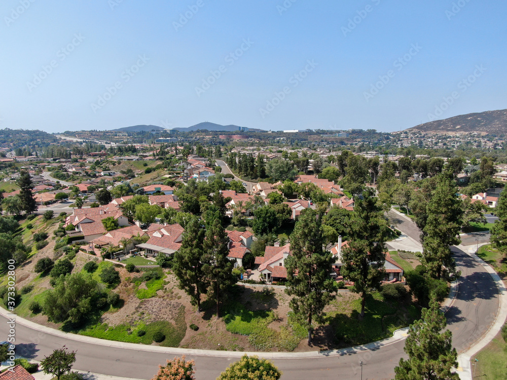 Aerial view of middle class neighborhood with residential house community and mountain on the background in Rancho Bernardo, South California, USA.