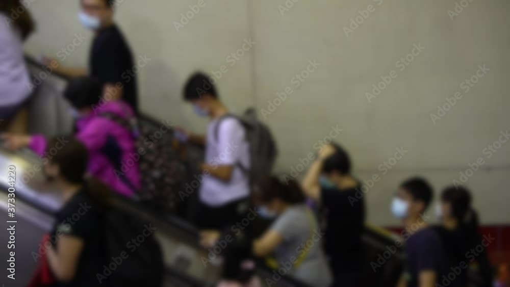 4K, Blurred defocused view of crowd people wearing surgical mask in subway entrance escalator. Coronavirus pneumonia has been spreading into many cities. 2019-nCoV epidemic of China.-Dan 4K, Blurred defocused view of crowd people wearing surgical mask in subway entrance escalator. Coronavirus pneumonia has been spreading into many cities. 2019-nCoV epidemic of China.-Dan