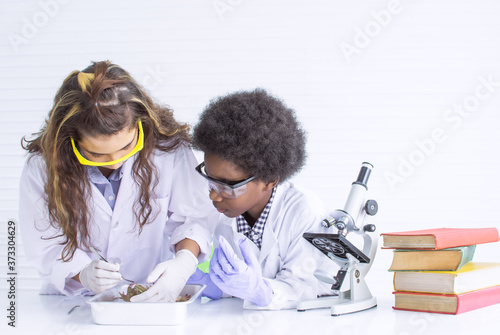 African black boy and caucasian girl studying science in classroom at school