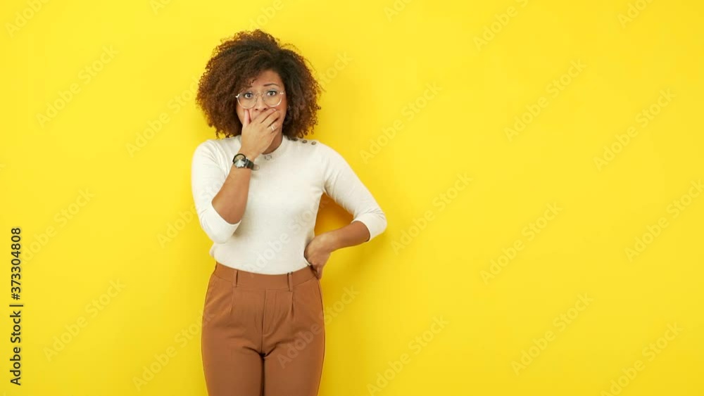 Young african american woman surprised and shocked Young african american woman surprised and shocked