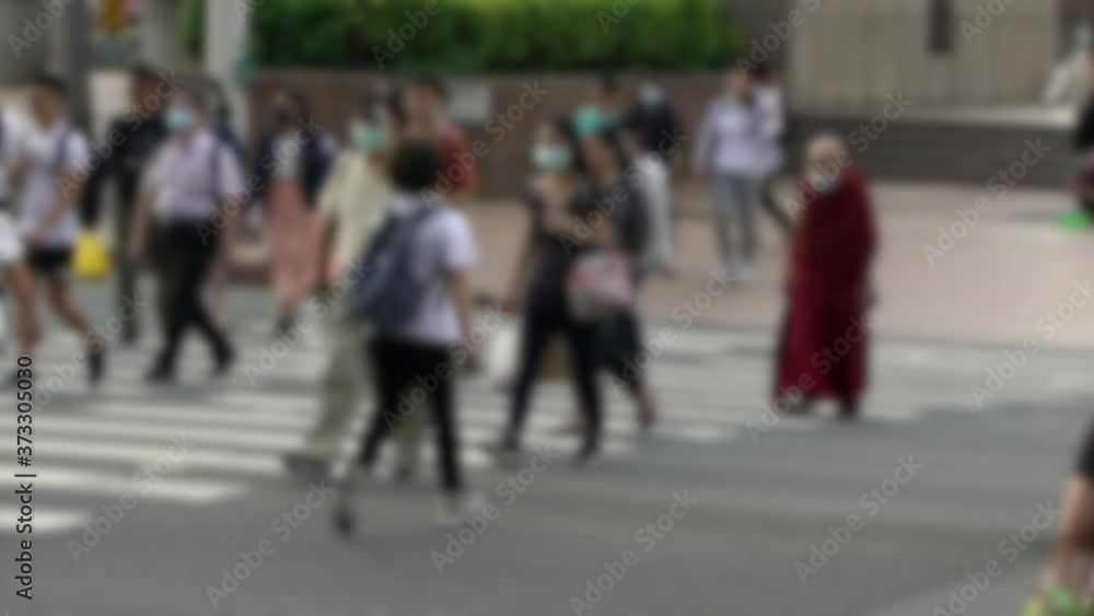 Slow motion of blurred defocused view of old asian monk wearing face masks during coronavirus outbreak. Spirituality man walking on scramble crossing street using surgical mask against covid19-Dan Slow motion of blurred defocused view of old asian monk wearing face masks during coronavirus outbreak. Spirituality man walking on scramble crossing street using surgical mask against covid19-Dan