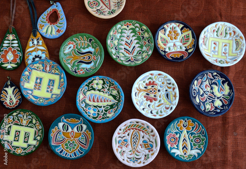 Traditional Crimean Tartar ceramics, painting: plates, saucers and pendats placed on tablecloth