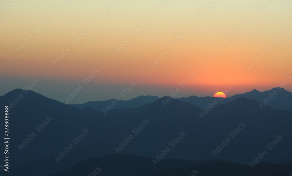 sunset in mountains. peaks and hills against clean sky sunset in mountains. peaks and hills against clean sky