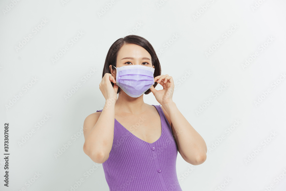 Asian pregnant woman wear face mask holding her belly, look at camera, isolated on white background, covid-19 concept Asian pregnant woman wear face mask holding her belly, look at camera, isolated on white background, covid-19 concept