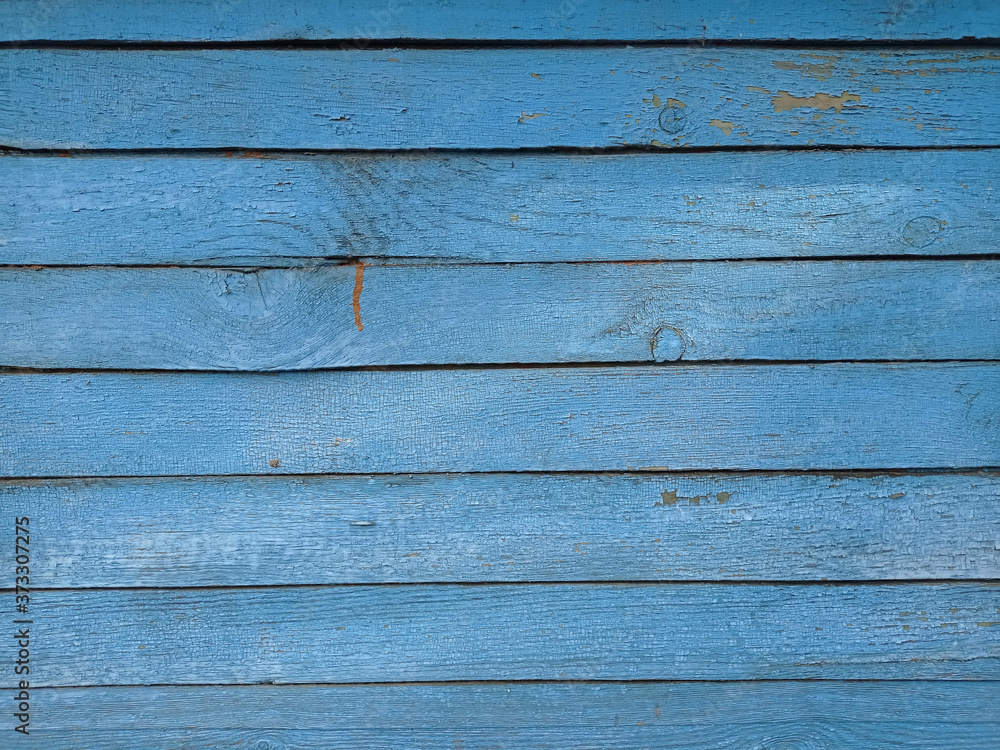 The texture of old wooden planks painted with blue paint The texture of old wooden planks painted with blue paint