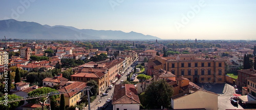 View of the old city from the top of the famous leaning tower in the city of Pisa, Italy © otmman
