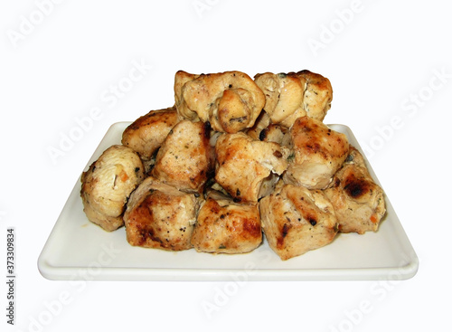 There is a square plate of grilled meat. White background. Isolated.