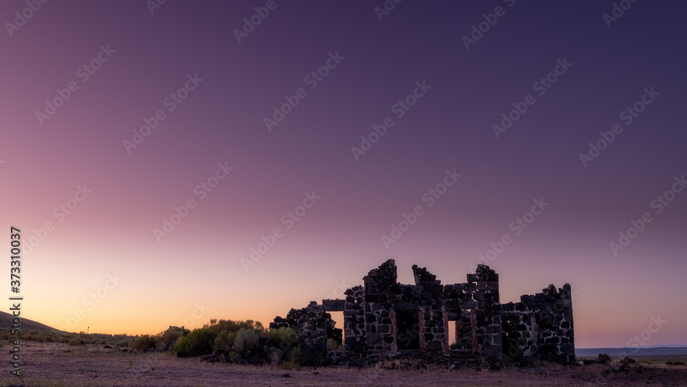Stone building ruins in the Idaho desert at sunset