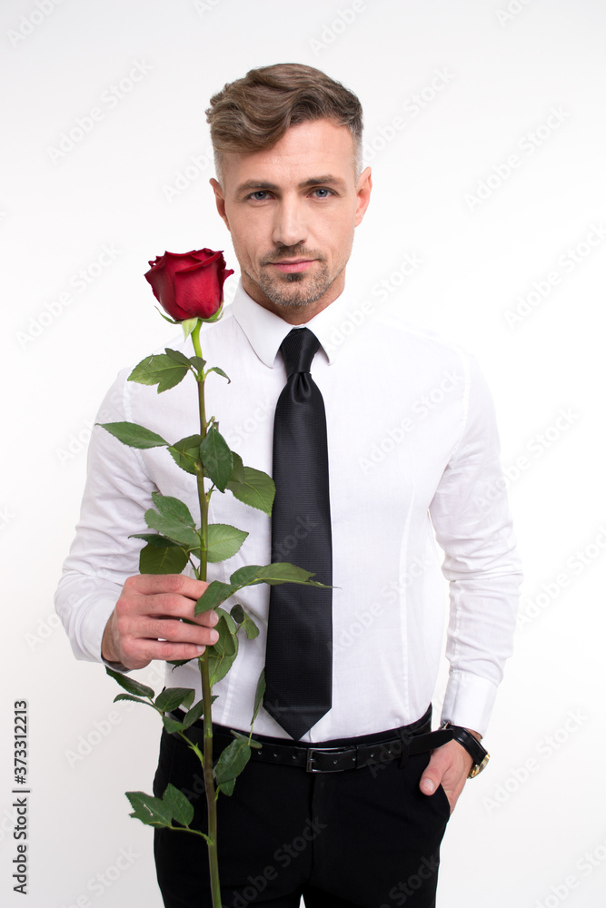 Elegant and handsome. Handsome young man holding red rose and looking at camera while standing against white background
Elegant and handsome. Handsome young man holding red rose and looking at camera while standing against white background