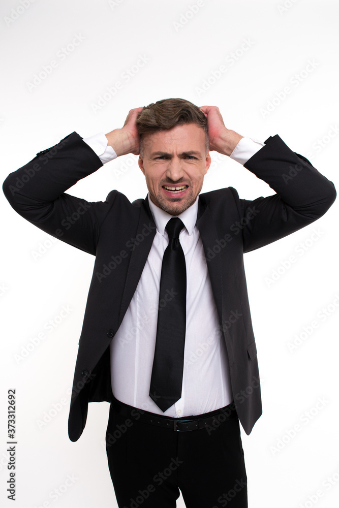 Real problems. Handsome young man keeping head in hands and looking at camera while standing against white background
Real problems. Handsome young man keeping head in hands and looking at camera while standing against white background