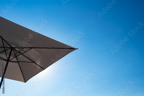 bottom view. beach umbrella against blue sky.