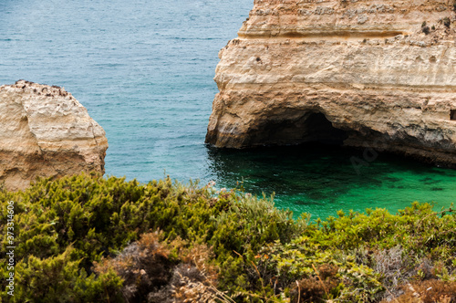 Carvalho beach.It is very popular due to its great beauty, its fine golden sand and its crystal blue waters. It is shaped like a "C" open to the sea and completely surrounded and closed by high cliffs