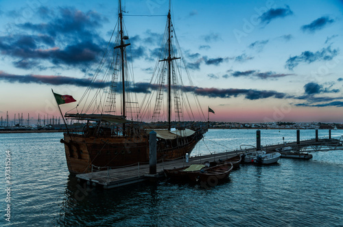 Recreational pirate ship in Portimao. Beautiful old ship that docks in the port of Portimao. Organize excursions for tourists. Made of wood  and with two masts  it transports us to the times of ancien