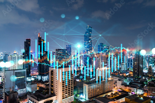 FOREX graph hologram  aerial night panoramic cityscape of Bangkok  the developed location for stock market researchers in Asia. The concept of fundamental analysis. Double exposure.