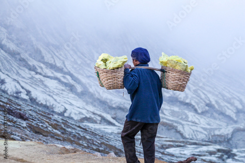 Sulfur miner carrying stones in Ijen volcano, Java Indonesia