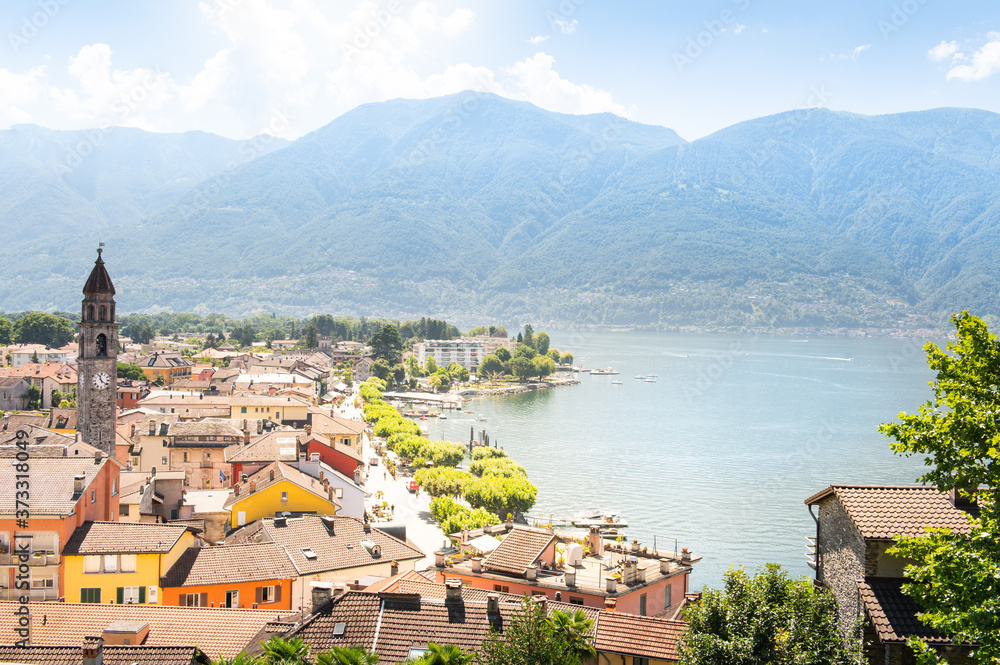City panorama of Ascona in Switzerland with old town, harbor promenade and marina in the most beautiful sunshine.