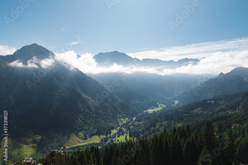Bavarian Landscape in the near from Oberstdorf in the morning with clouds and trees.