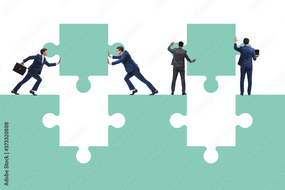 Businessman in teamwork concept with jigsaw puzzle Businessman in teamwork concept with jigsaw puzzle