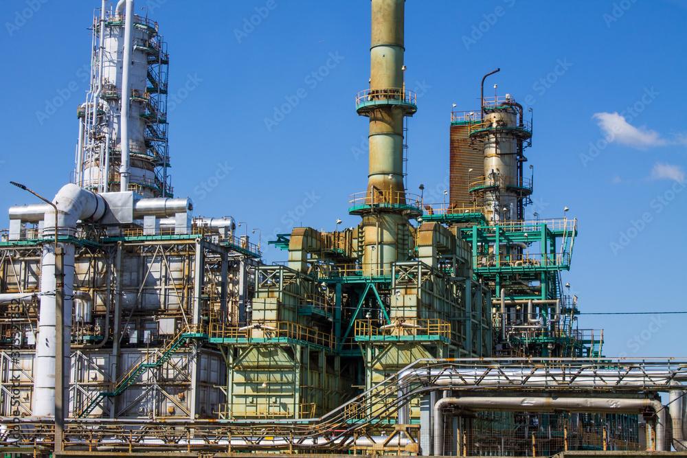 an oil refinery with industrial structures outdoors against a blue sky and space for copying in Yaroslavl Russia