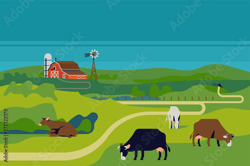 Peaceful rural cattle farm landscape with farm barn, silo and dairy cows in grassland meadows environment