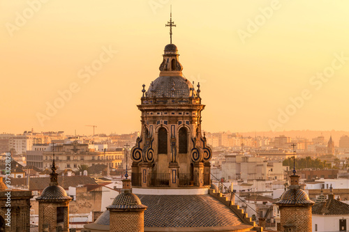 Sunset Seville - A close-up golden sunset view of the dome and bell tower at top of the 16th-century Renaissance style Iglesia de la Anunciación - The Annunciation Church in Seville, Andalusia, Spain.