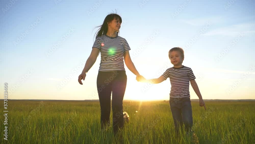 Happy family together.Mother and son walk in the open air in the countryside, lead a healthy lifestyle.The concept of teamwork, family reunion. Happy family together.Mother and son walk in the open air in the countryside, lead a healthy lifestyle.The concept of teamwork, family reunion.