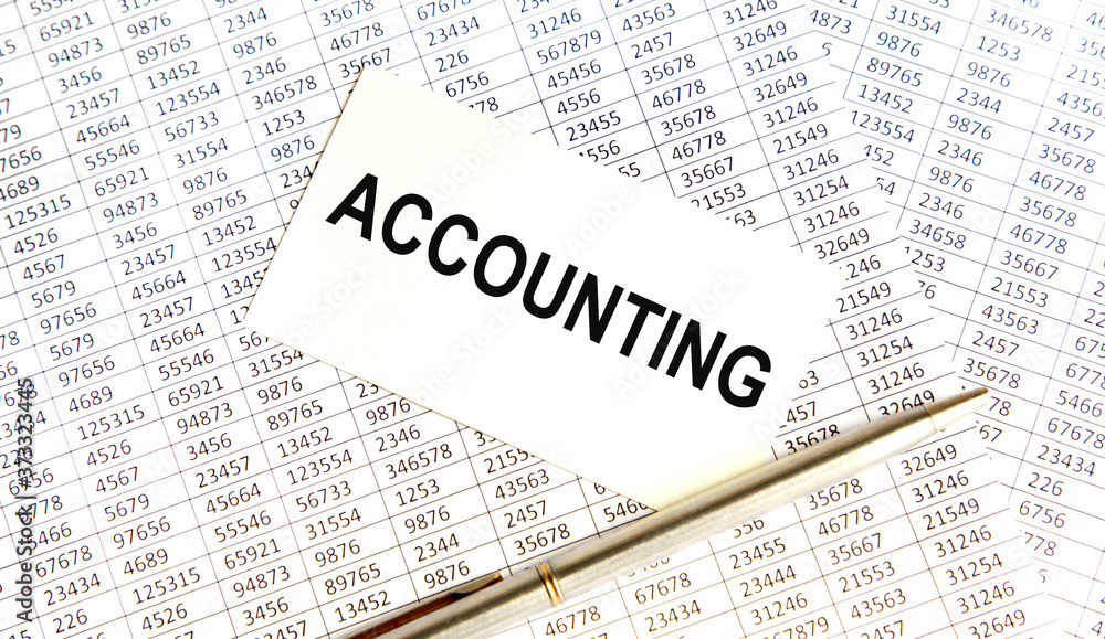 Finance and business concept. The businessman has on his desk graphs with reports, a notebook, a magnifying glass and a document with the inscription - ACCOUNTING Finance and business concept. The businessman has on his desk graphs with reports, a notebook, a magnifying glass and a document with the inscription - ACCOUNTING