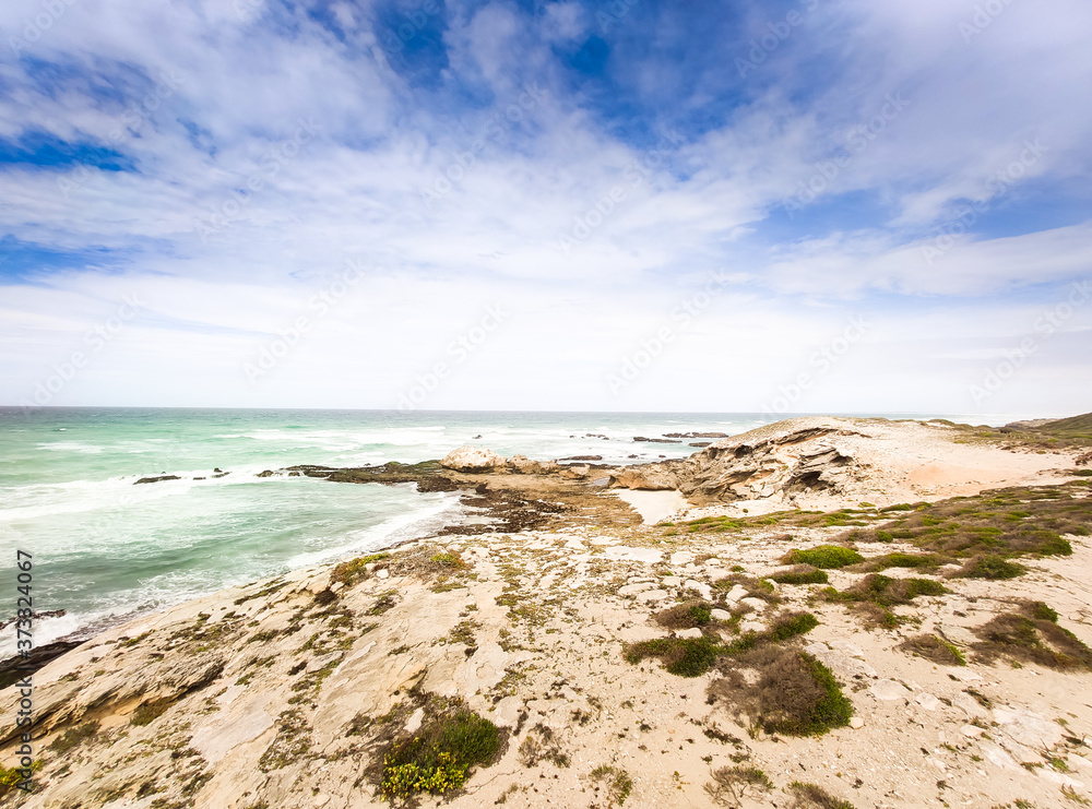 Blue cloudy sky and yellow sand on the coast in De Hoop Nature Reserve in South Africa