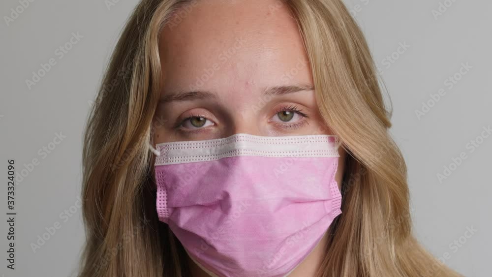 Young blond caucasion girl wears pink mouth mask 4k 50fps Young blond caucasion girl wears pink mouth mask 4k 50fps