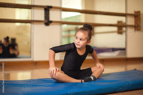 Kid at gymnastic class doing exercises. Children and sport concept