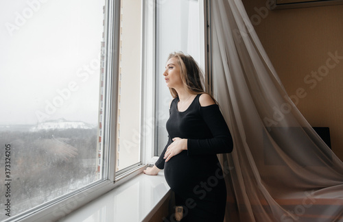 A pregnant girl is breathing fresh air from the window Free Download A pregnant girl is breathing fresh air from the window - GFXLoad