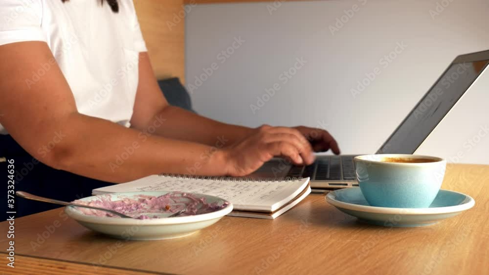 freelance woman works with a laptop in a cafe freelance woman works with a laptop in a cafe