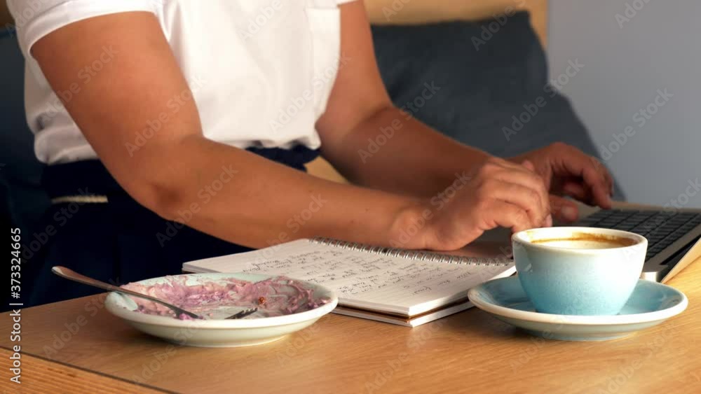 freelance woman works with a laptop in a cafe freelance woman works with a laptop in a cafe
