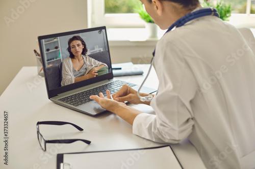 Telemedicine or telehealth concept.A young woman doctor in her office gives an online consultation.
