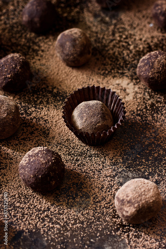 Truffles - chocolate french sweets (candies) covered with cocoa. Closeup view