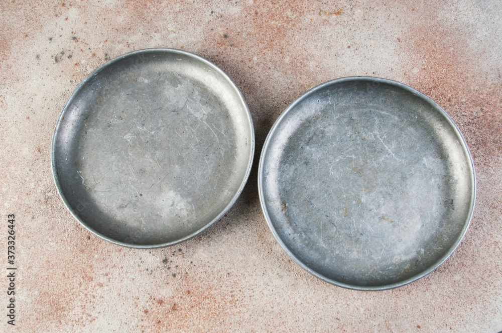 Old metal plates for scales on concrete background. Old metal plates for scales on concrete background.