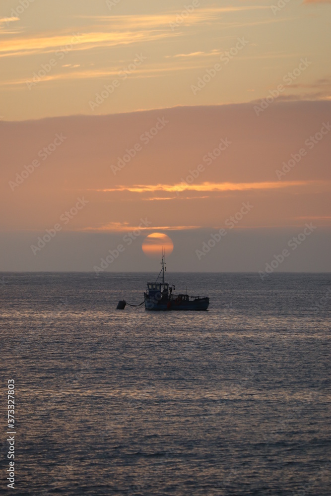 fishing boat at sunset, outer hebrides, scotland