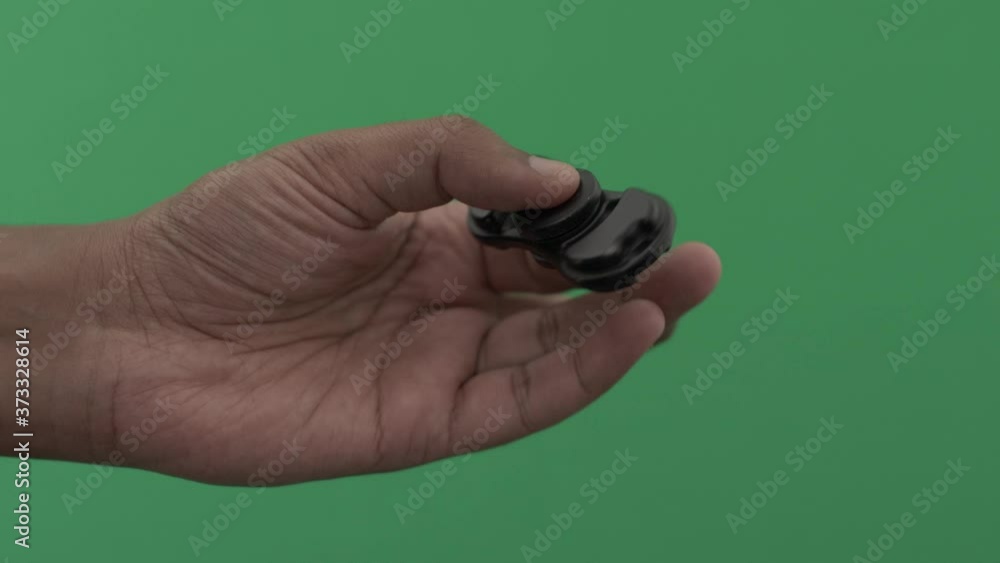 Right Male Hand Spinning Fidget Spinner. Green Screen, Locked Off Right Male Hand Spinning Fidget Spinner. Green Screen, Locked Off