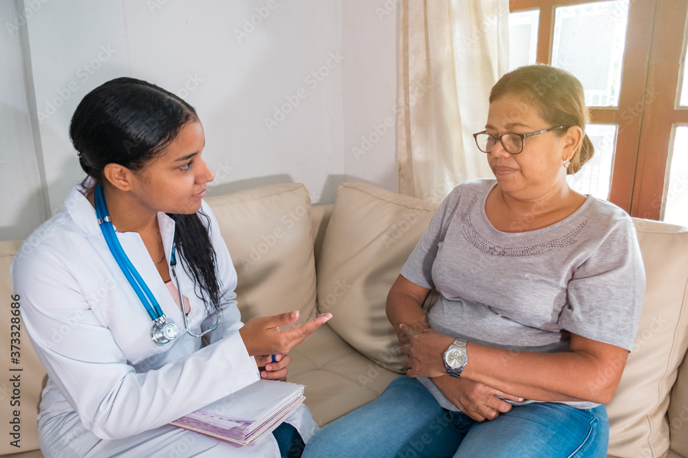 Latin Doctor explaining diagnosis to his female patient Latin Doctor explaining diagnosis to his female patient