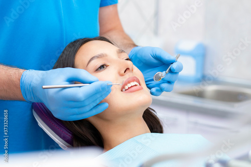 dentist examines the patients teeth at the dentist.