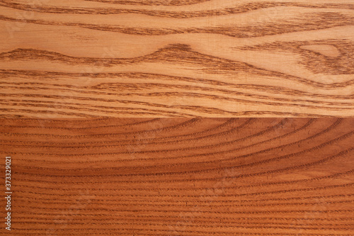 The structure of natural ash wood, tinted oak. Hardwood. Creative vintage background. Imitation of aging.