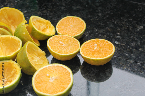 oranges for juice on dark granite countertops  space for writing