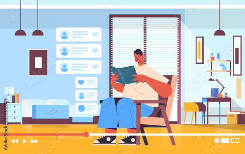 male blogger reading book recording online video blog live streaming blogging concept living room interior horizontal full length vector illustration