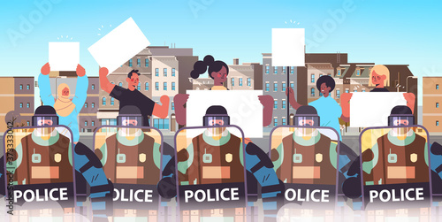 policemen in full tactical gear riot police officers controlling mix race street protesters with placards during clashes demonstration protest riots mass concept portrait cityscape horizontal vector