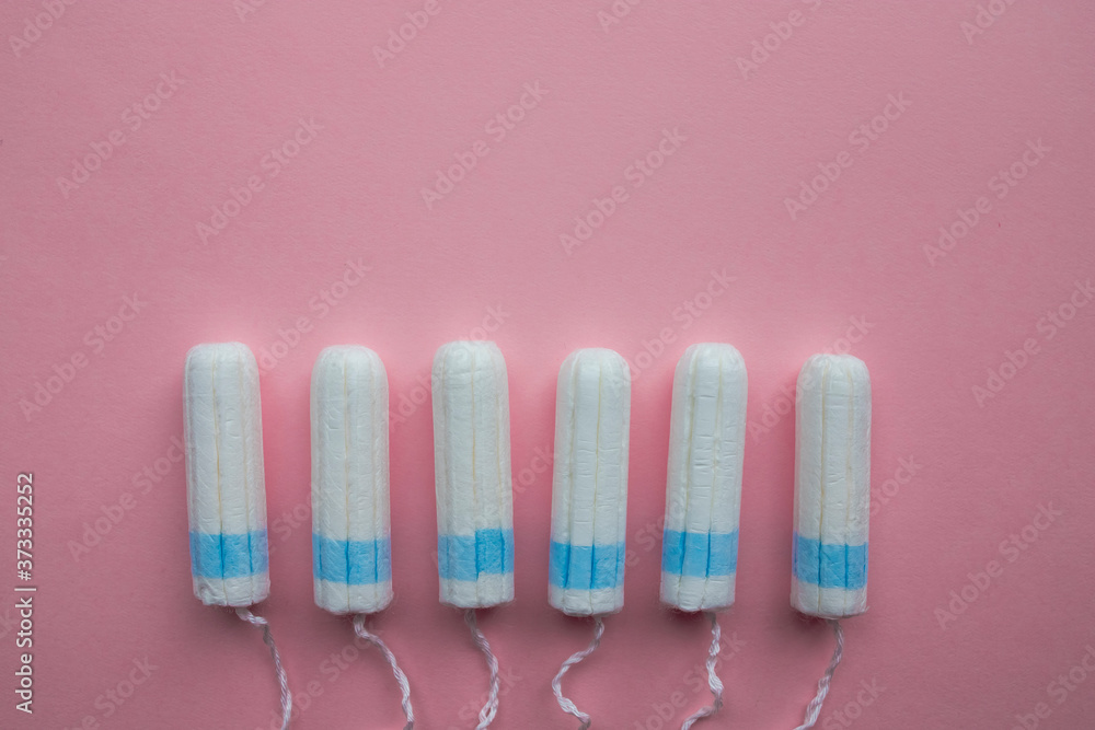 Disposable tampons flat lay on pink background. Disposable tampons flat lay on pink background.
