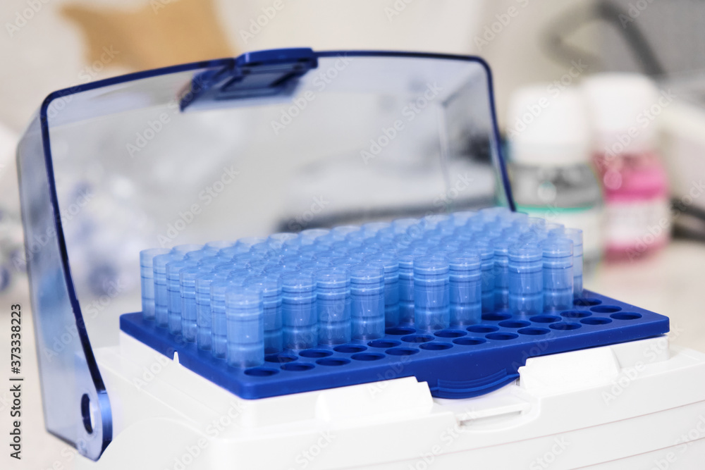 Blue one millilitre pipette tips in the box. Chemical laboratory. Blue one millilitre pipette tips in the box. Chemical laboratory.